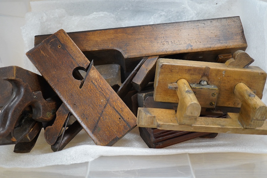 A collection of wooden carpenters tools, including various planes, two saws and a marking gauge, longest plane 73cm long. Condition - some blades missing